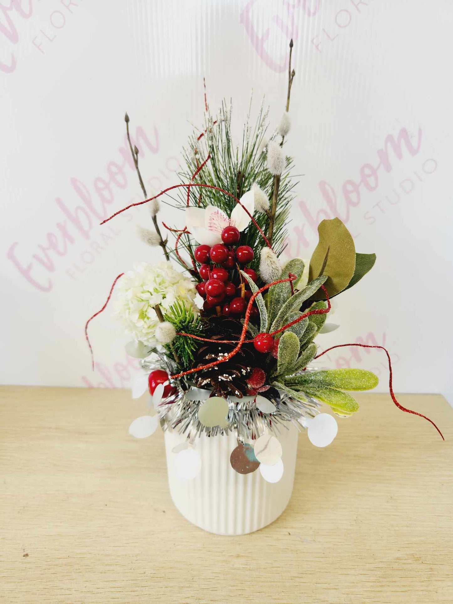 One of a kind Christmas Arrangement in a white ceramic pot, display on a side table in the entrance of your home or even decorate your table for Christmas family lunch.

If you can't make Christmas with that special someone send this gift to let them know you are thinking of them this Christmas

Made with a variety of Christmas decorations